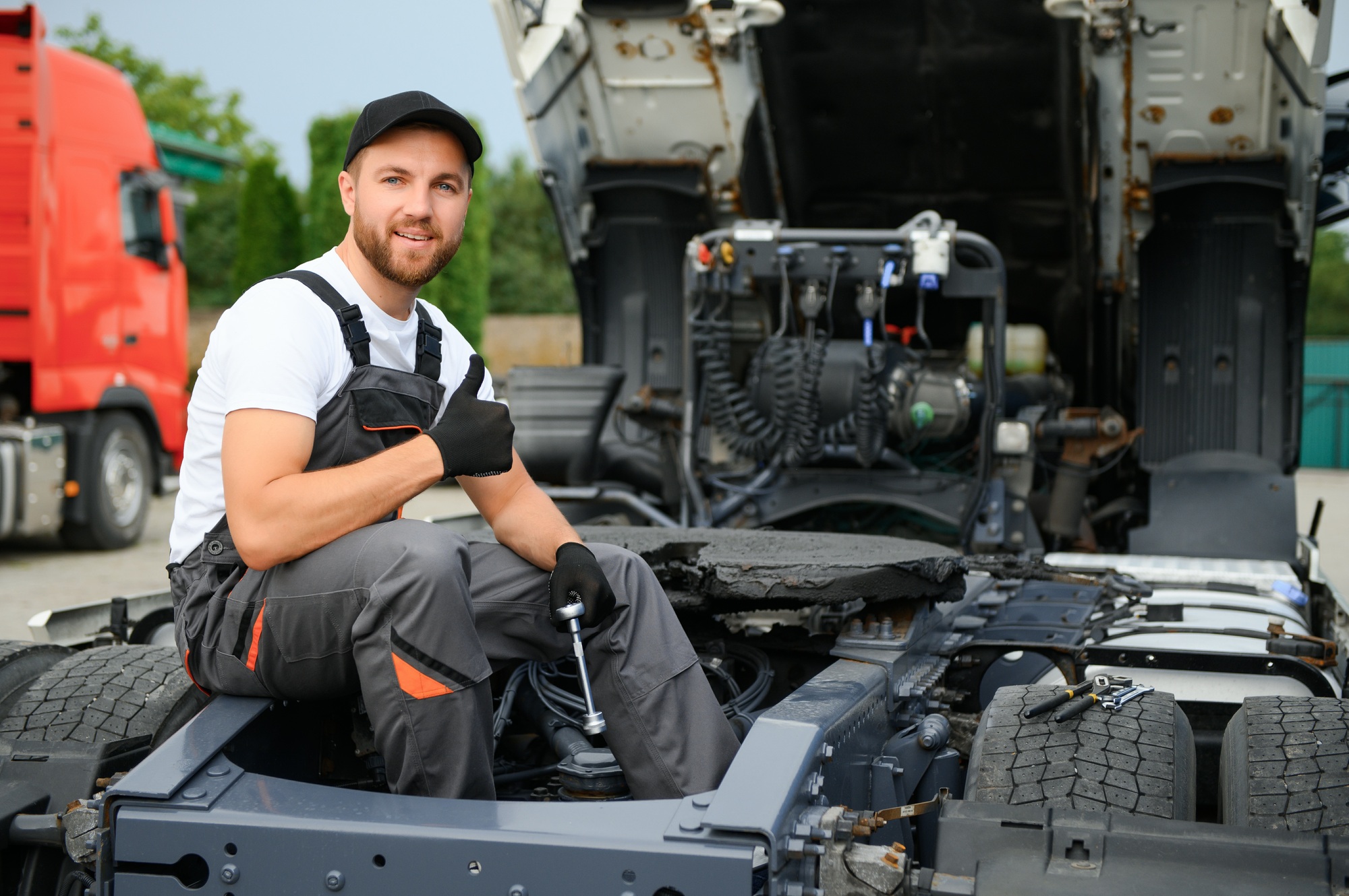 Caucasian Truck Service Worker in His 30s Performing Scheduled Recall Maintenance.