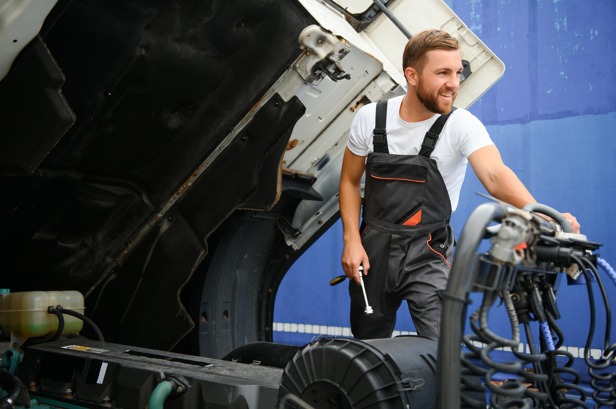 Professional truck mechanic working in vehicle repair service.